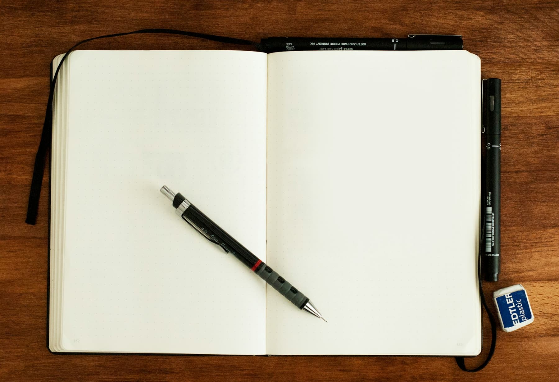 A pen on the blank pages of an open journal