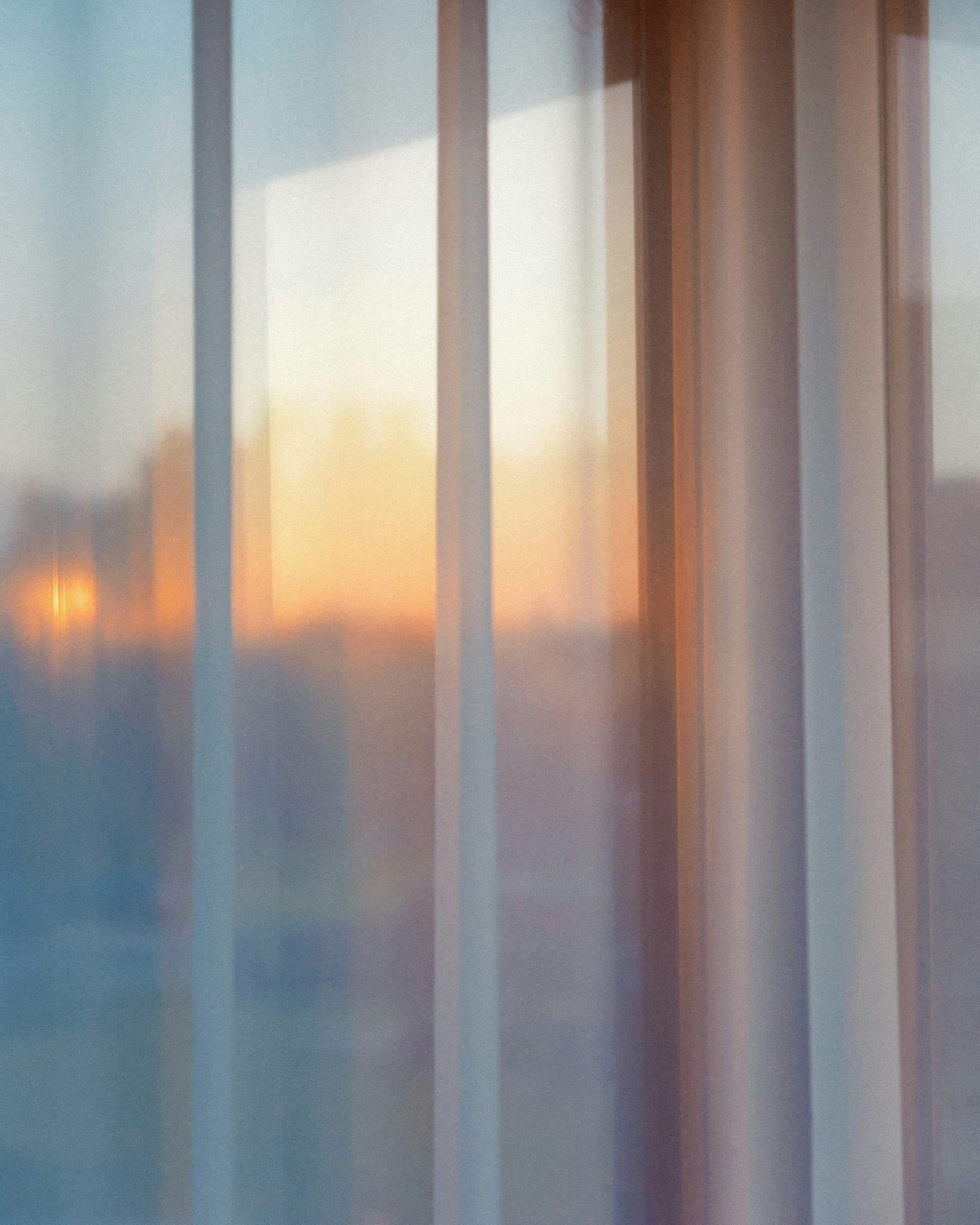 Warm evening light through sheer curtains